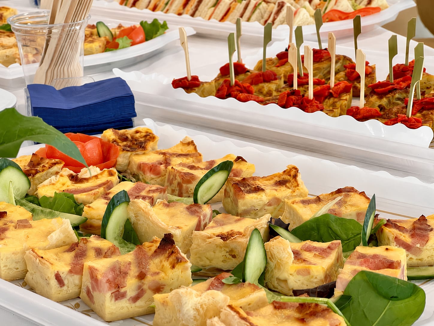 Catering platters of mini burgers, sandwiches, croquettes and tortilla wraps with Freska allergen labels
