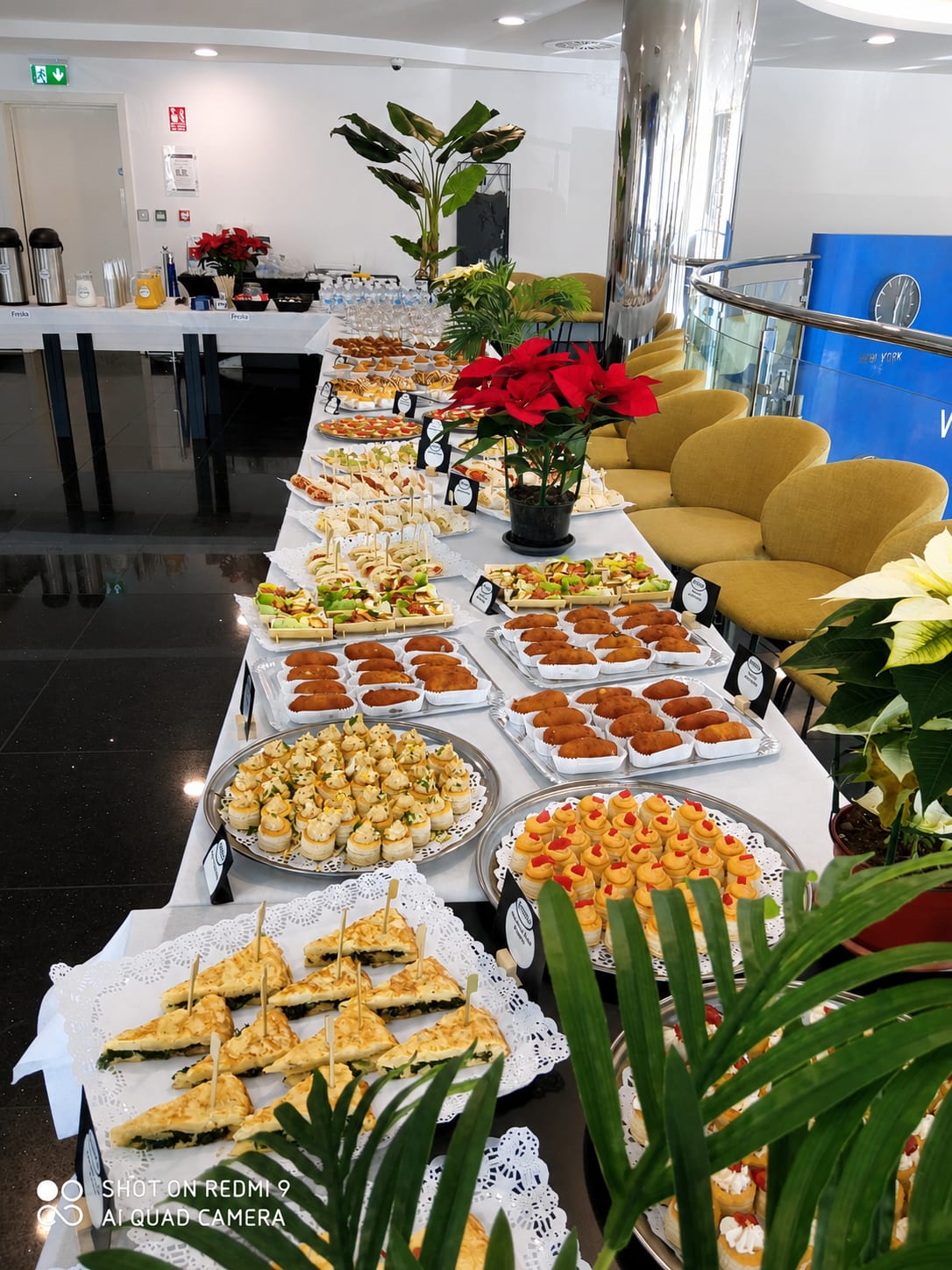 Long buffet table of catering trays and canapés set up for a corporate event