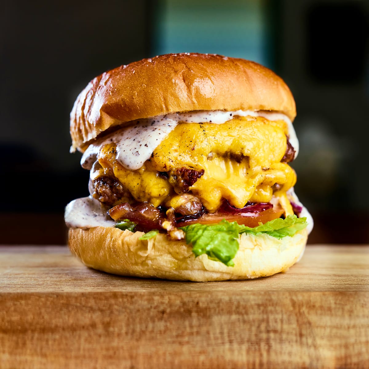 Stacked cheeseburger with melted cheddar and creamy sauce