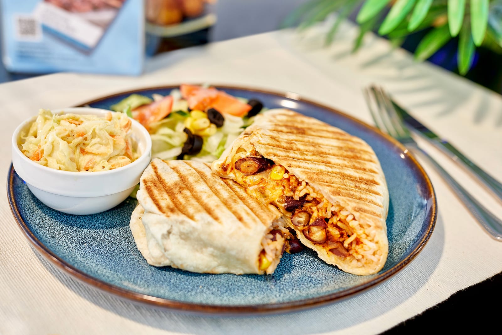 Grilled quesadilla filled with rice and beans, served with coleslaw and side salad