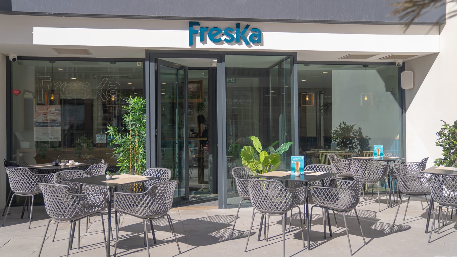 Freska storefront with outdoor terrace seating on a sunny pavement