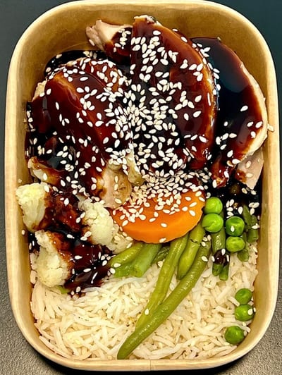 Meal-prep box of teriyaki chicken with sesame seeds, rice and vegetables