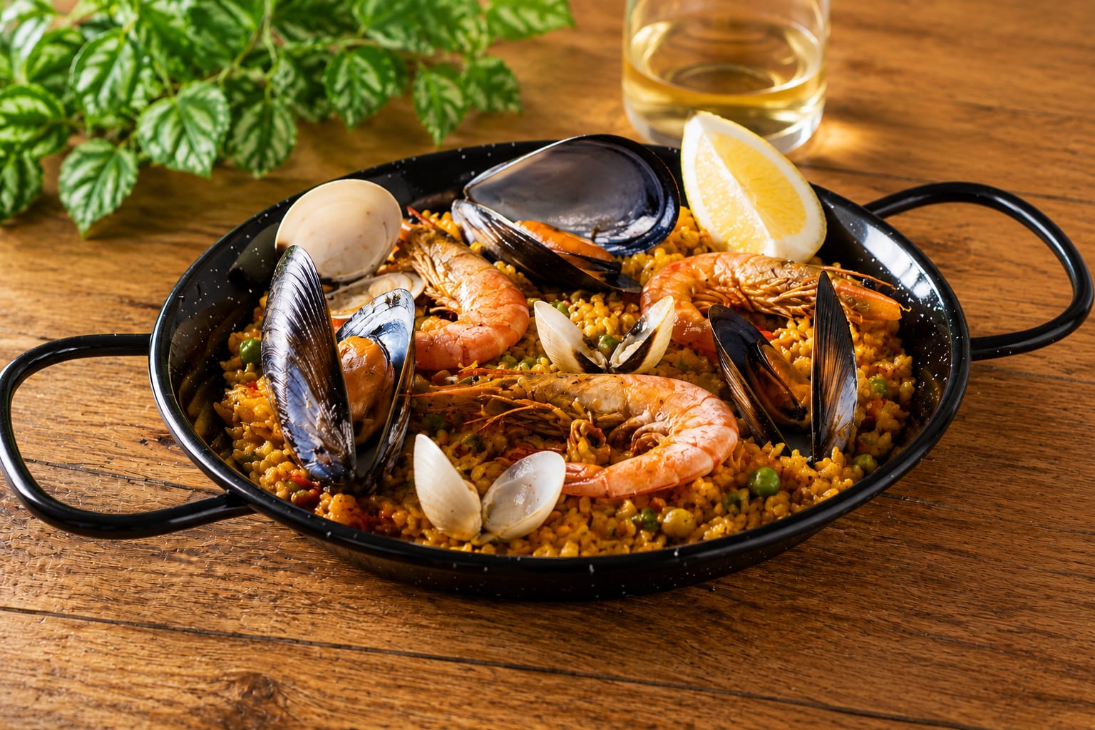 Seafood paella with prawns, mussels and clams in a traditional pan