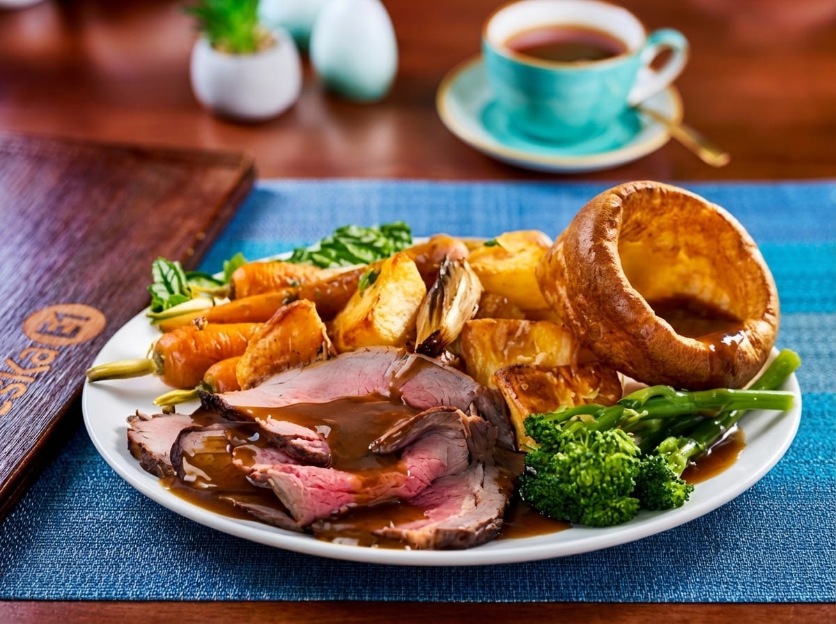 Sunday roast with sliced beef, Yorkshire pudding, roast potatoes and vegetables
